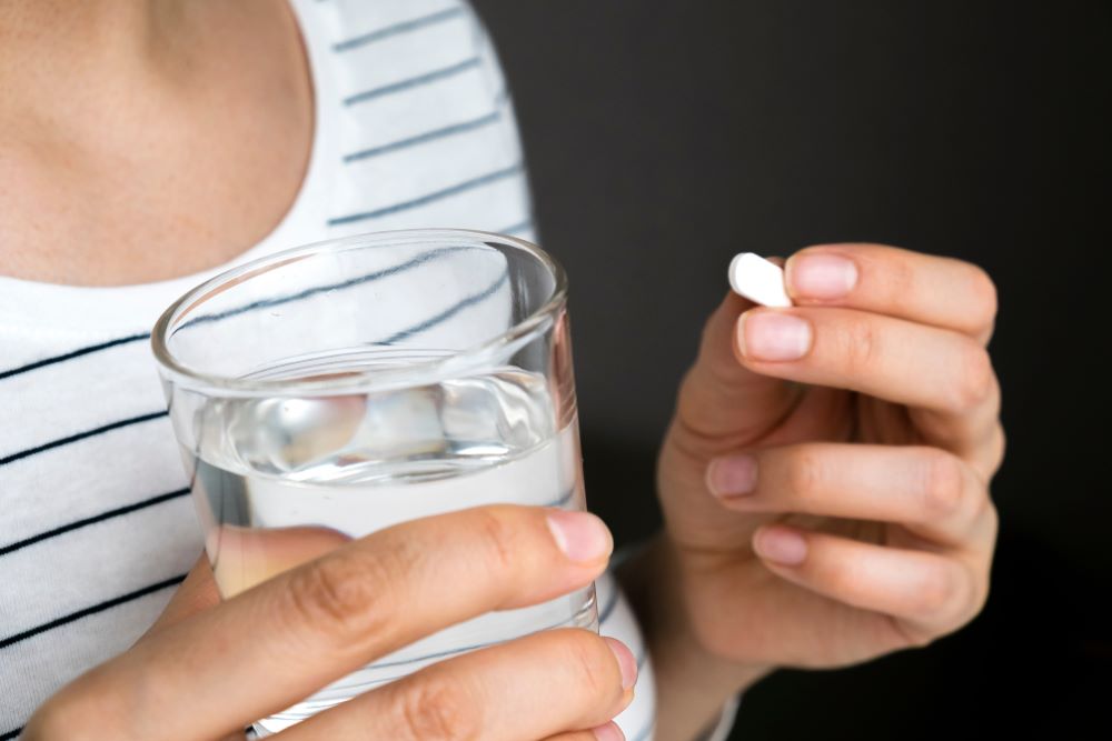 taking a paracetamol tablet